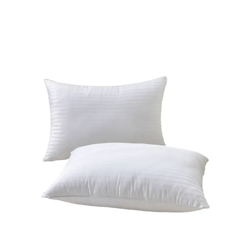 White cotton satin stripe feather pillow showing simple design on a bed.
