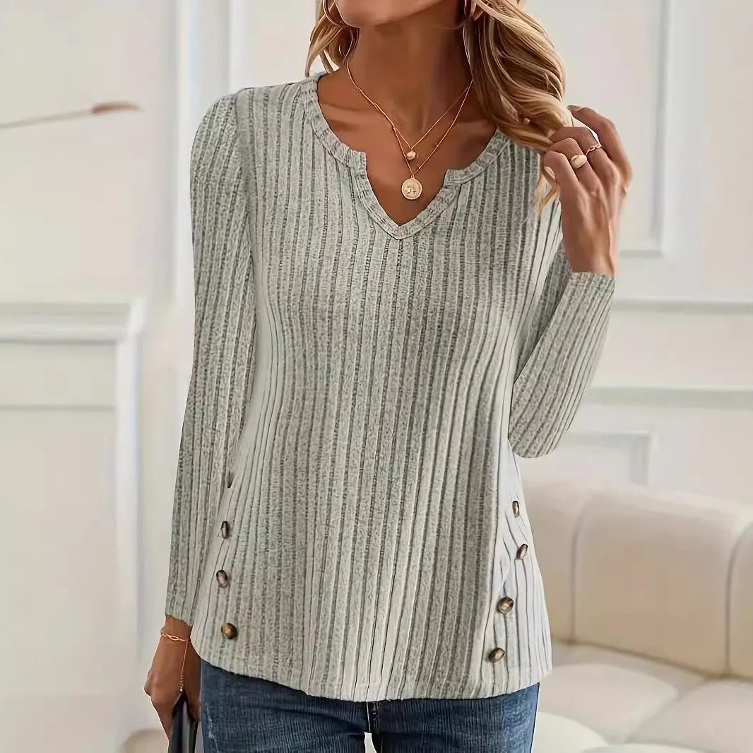 Solid colour casual knitted pullover sweater with a button detail on a hanger.
