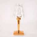 Rose gold portable touch night light with acrylic lamp holder on a surface