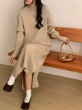Half turtleneck long sleeve knitted dress with a high waist and mid-length skirt in a solid colour.