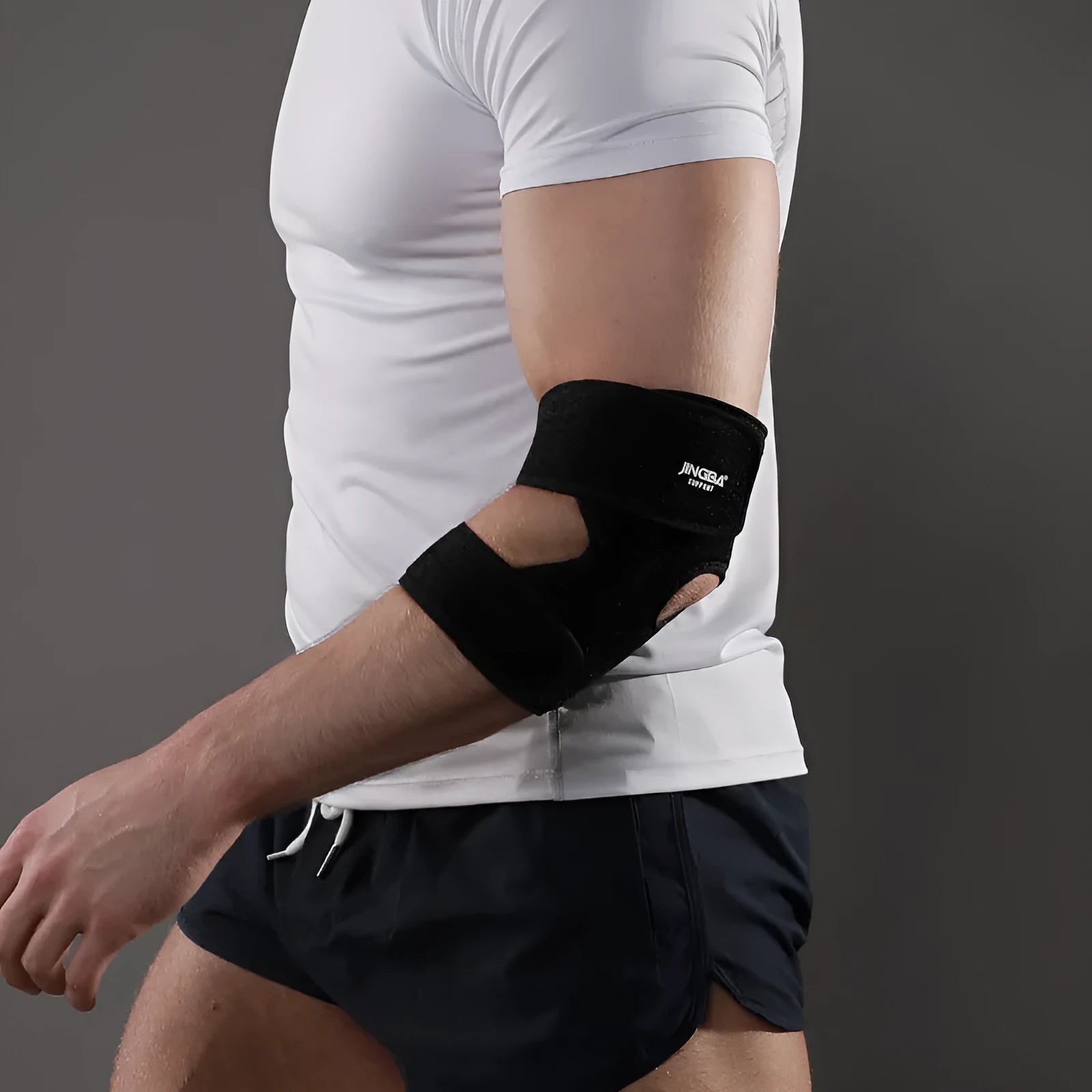 A black adjustable sports elbow guard for adult use in basketball, badminton, and outdoor training.