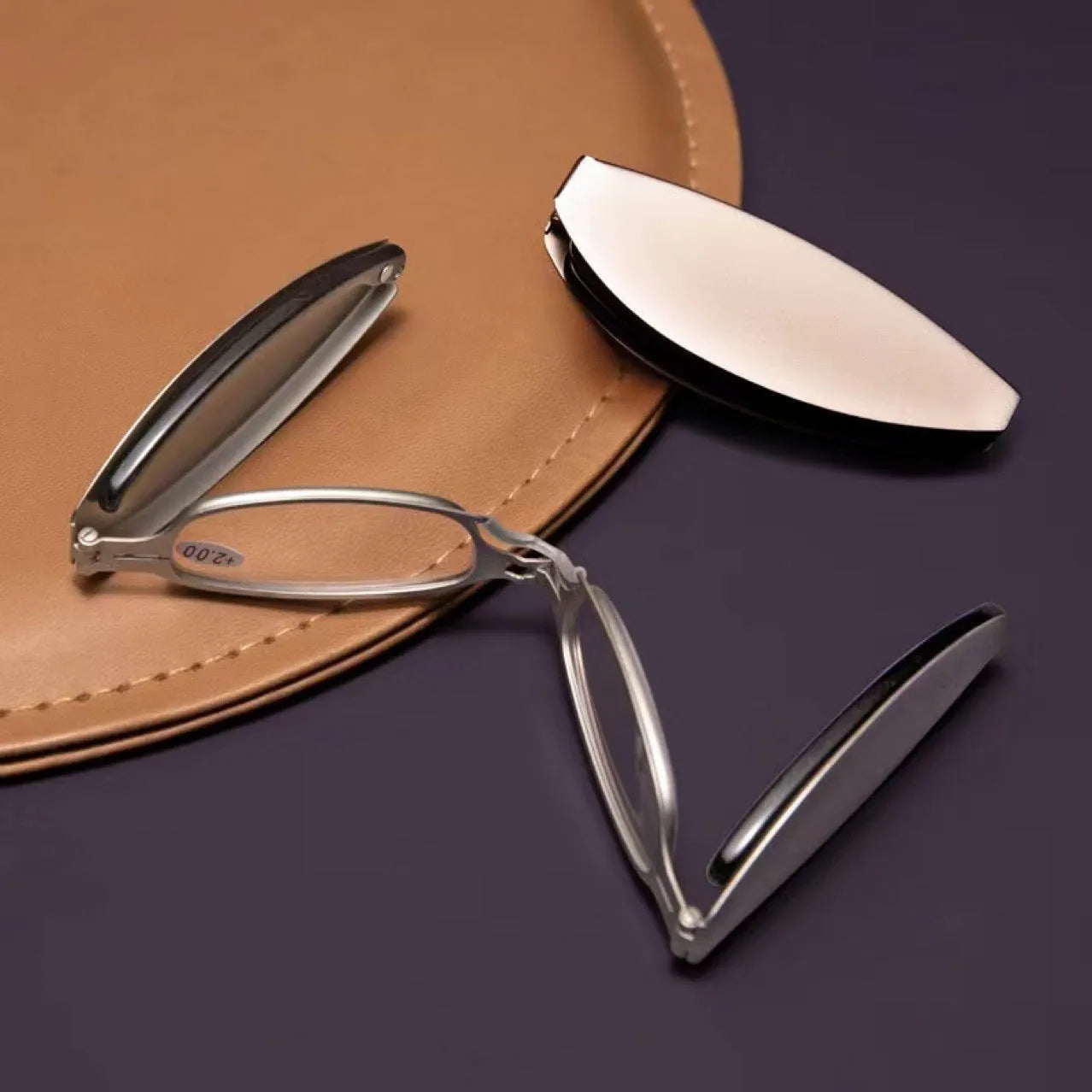 Folding presbyopic glasses with retro ring design in black frame collapsed for pocket storage