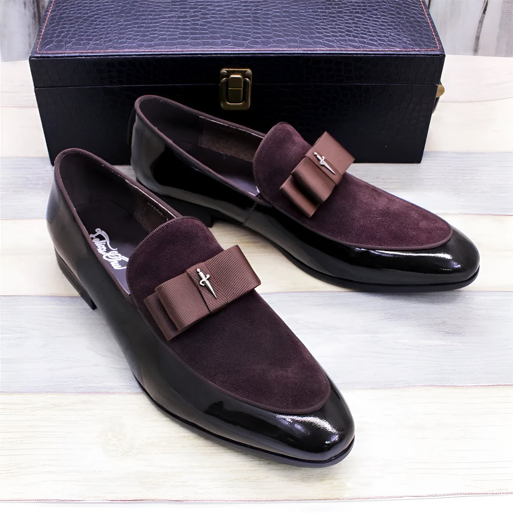 Men's low-top leather shoes in black with a tassel detail and glossy patent leather accents.