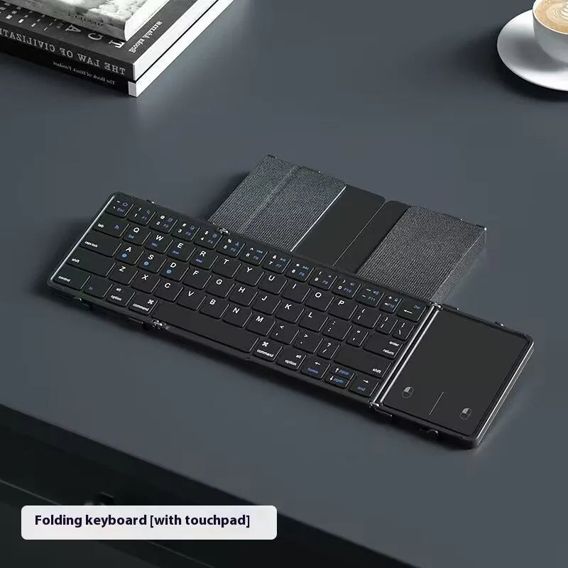 Black folding Bluetooth keyboard for mobile phones and tablets showing folded and unfolded positions