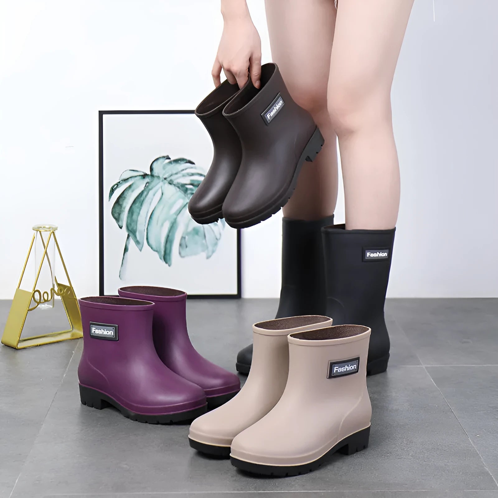 Women's mid-calf rain boots in black, PVC upper, shown with a low heel.