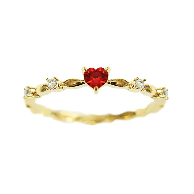 Gold or silver personalised zircon peach heart ring showing five available sizes on a ring sizer.