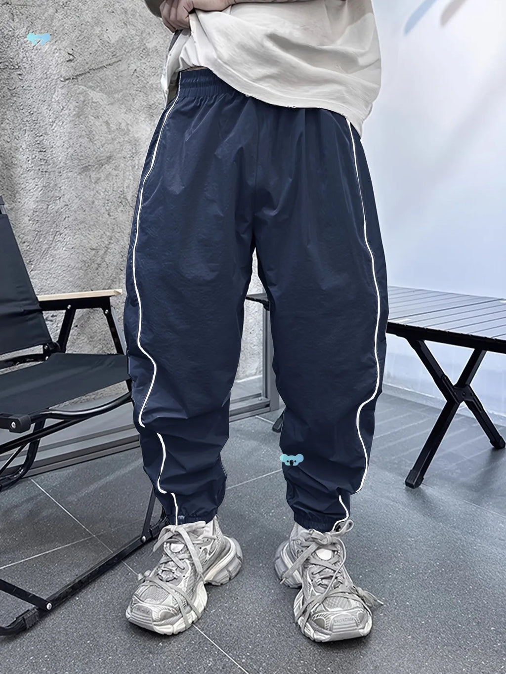 Man wearing loose-fit, cropped-length casual trousers in bamboo fibre, shown in khaki colour