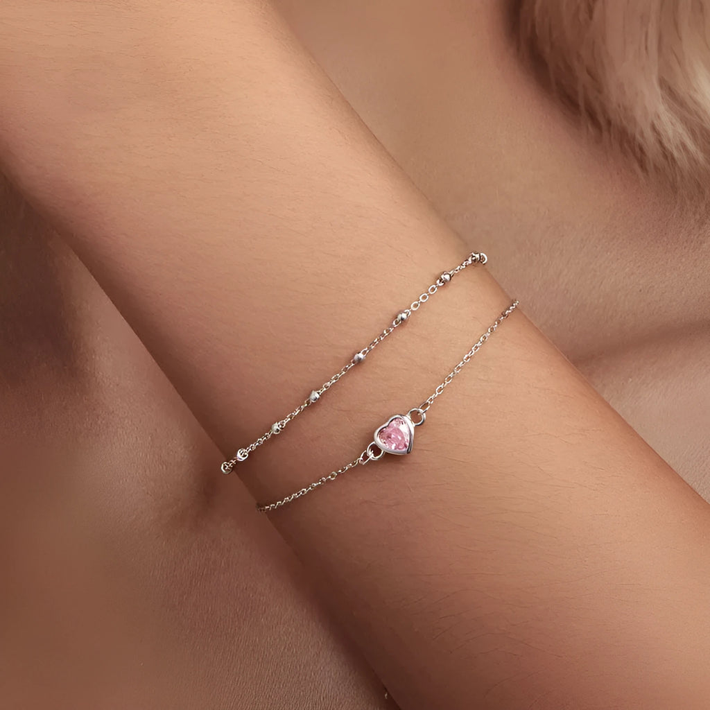 Women's sweet style sterling silver bracelet with a small heart-shaped charm on an adjustable chain.