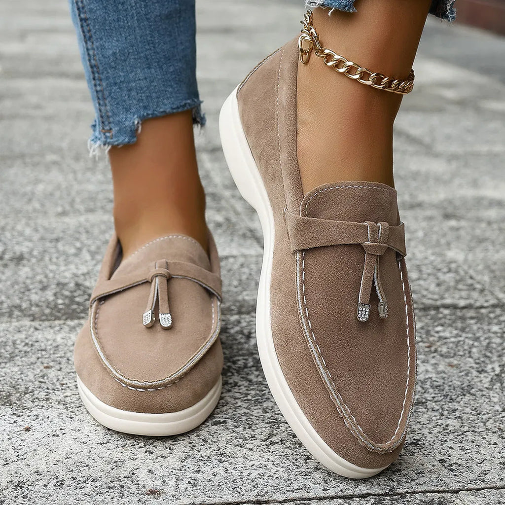Canvas slip-on loafers in brown with round toe, rubber sole, and platform heel.