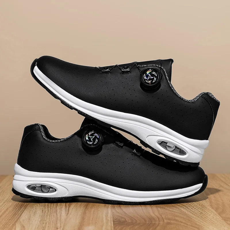 Black and white low top casual shoes with mesh upper, composite sole, and cross shoulder straps