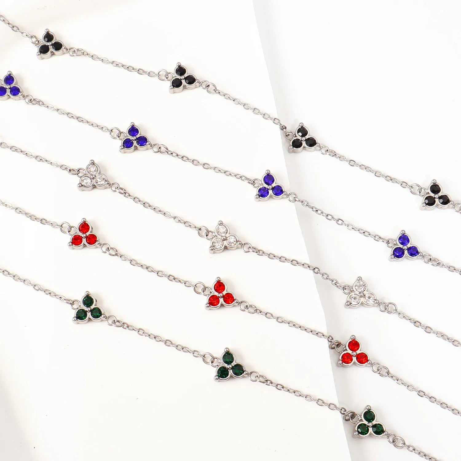 Stainless steel women's bracelet with three diamond geometric design and gemstone settings
