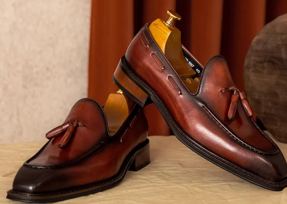 Men's genuine leather slip-on loafers in black and brown with fringed detailing and rubber soles
