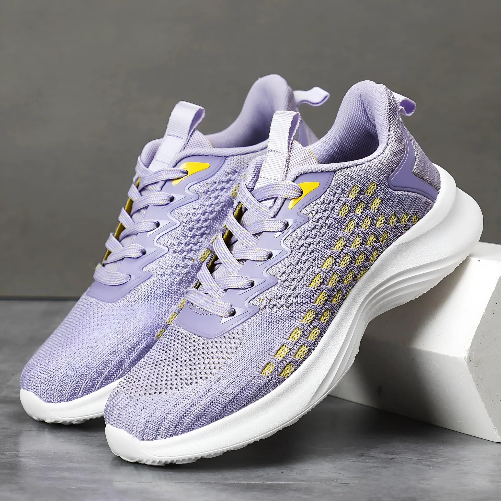 Women's lavender purple Flyknit running shoes with mesh lining and EVA sole on a white background.