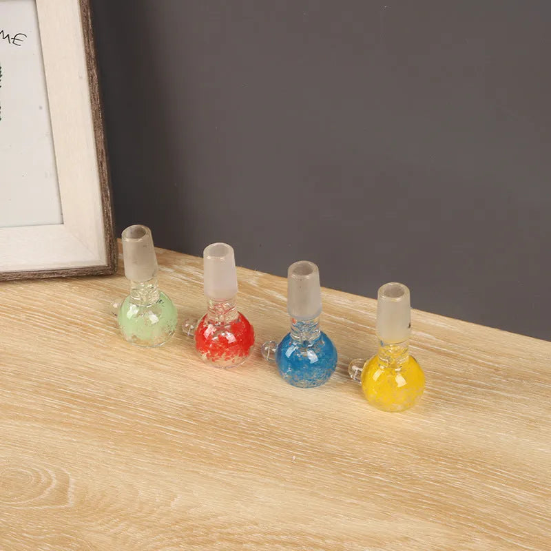 Transparent coloured glass tobacco pipe, trumpet shape, 7cm tall, on a plain background.