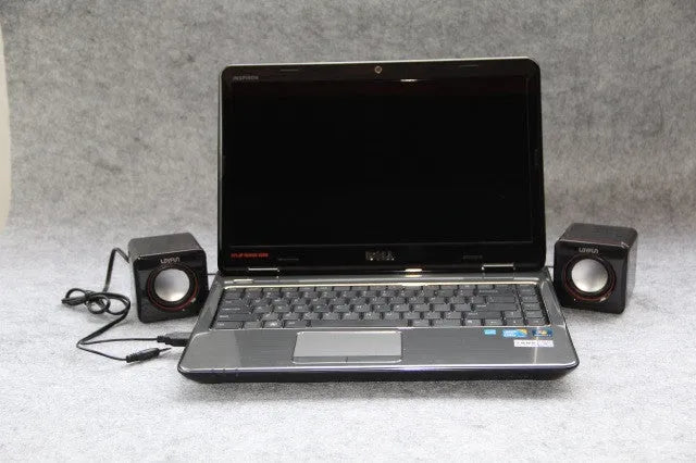 Small square black USB speaker for Model 700B computer on a desktop