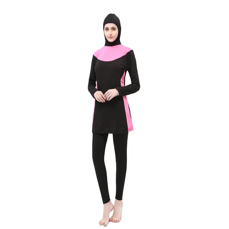 Women's black and blue hooded long sleeve swimsuit top and pants on a hanger.