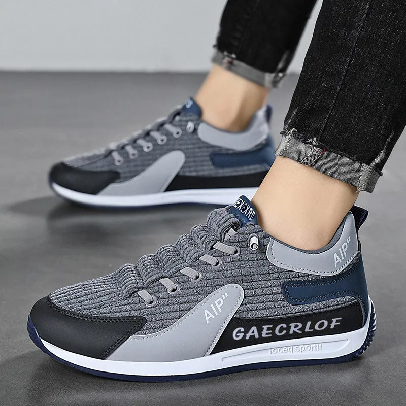 Men's grey and green mesh low-top lace-up running shoes on a white background.