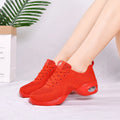 Women's white breathable mesh dance shoe with a lightweight PU sole on a studio floor.