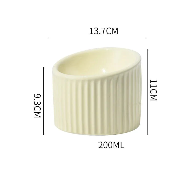 Ceramic elevated cat bowl in green colour showing tilted design for whisker comfort