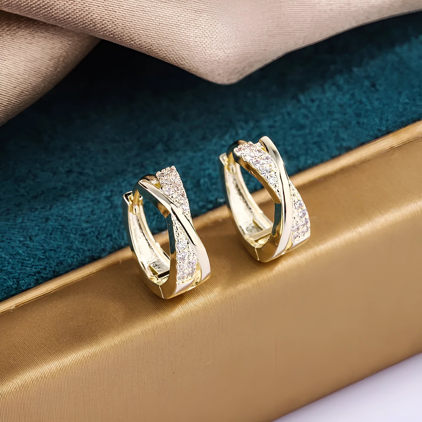 Geometric 14K yellow gold-plated earrings with zircon detailing on white background