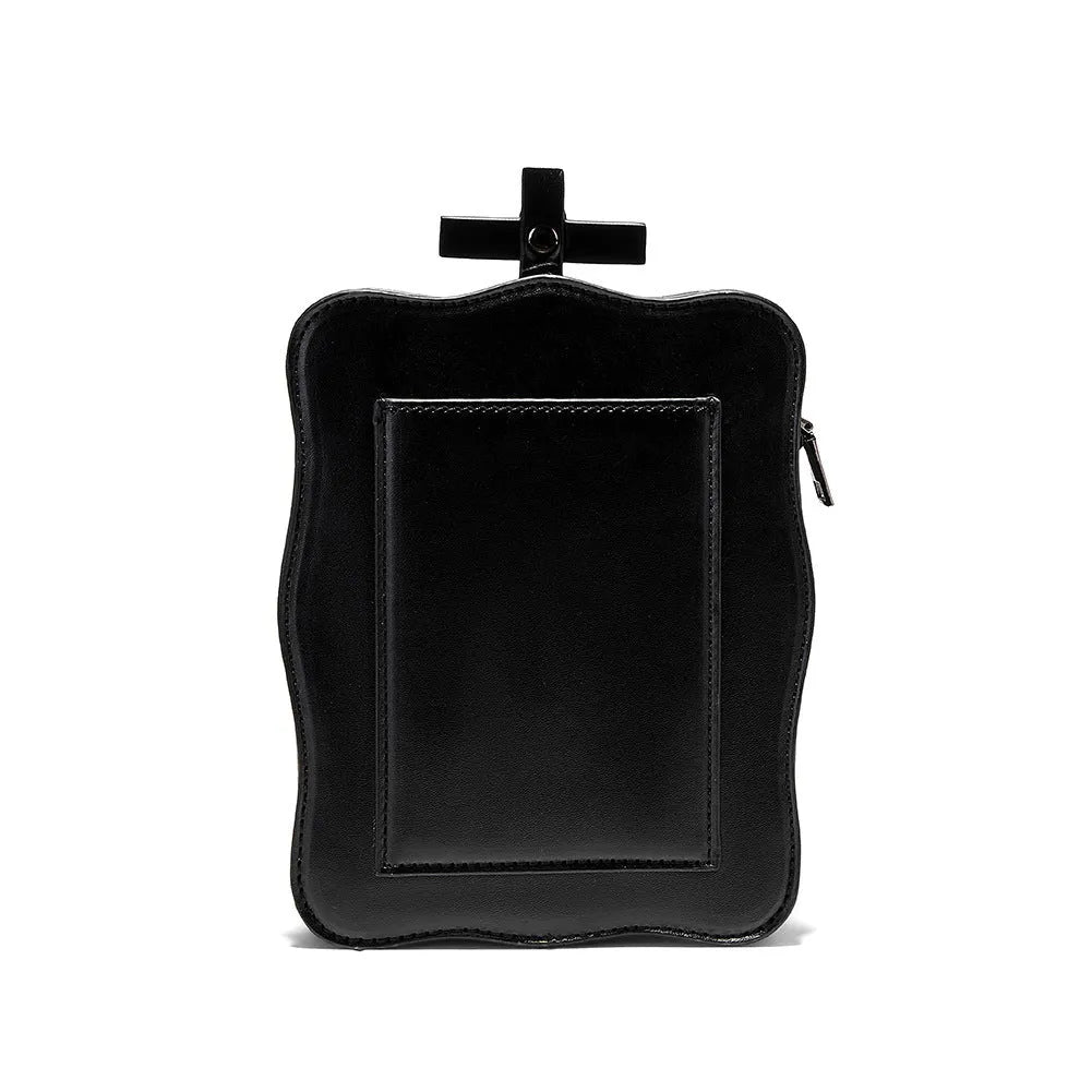 Black square crossbody bag with embossed skull design, chain accents, and zip opening