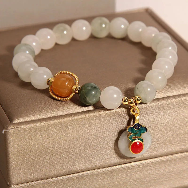 Women's ice jade bracelet with pearl accents and xiangyun peace jade buckle in retro design