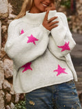 White women's loose fit turtleneck sweater with a black five-pointed star pattern on the front.