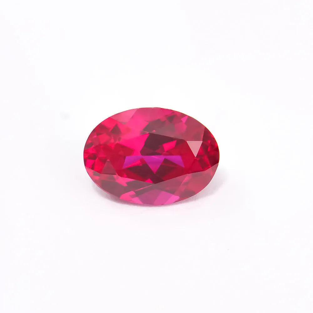 Loose cultivated ruby gemstone in pigeon blood red colour on a white background, shown in different cuts.
