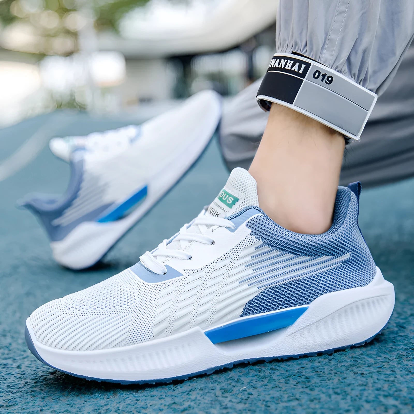A pair of blue men's casual mesh sports shoes with a round toe and cloth upper.