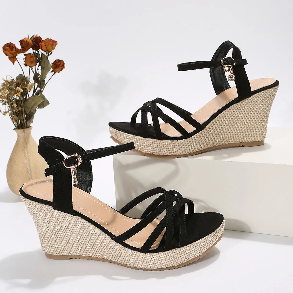 Beige and black women's wedge sandals with a cloth upper and fish mouth toe opening.