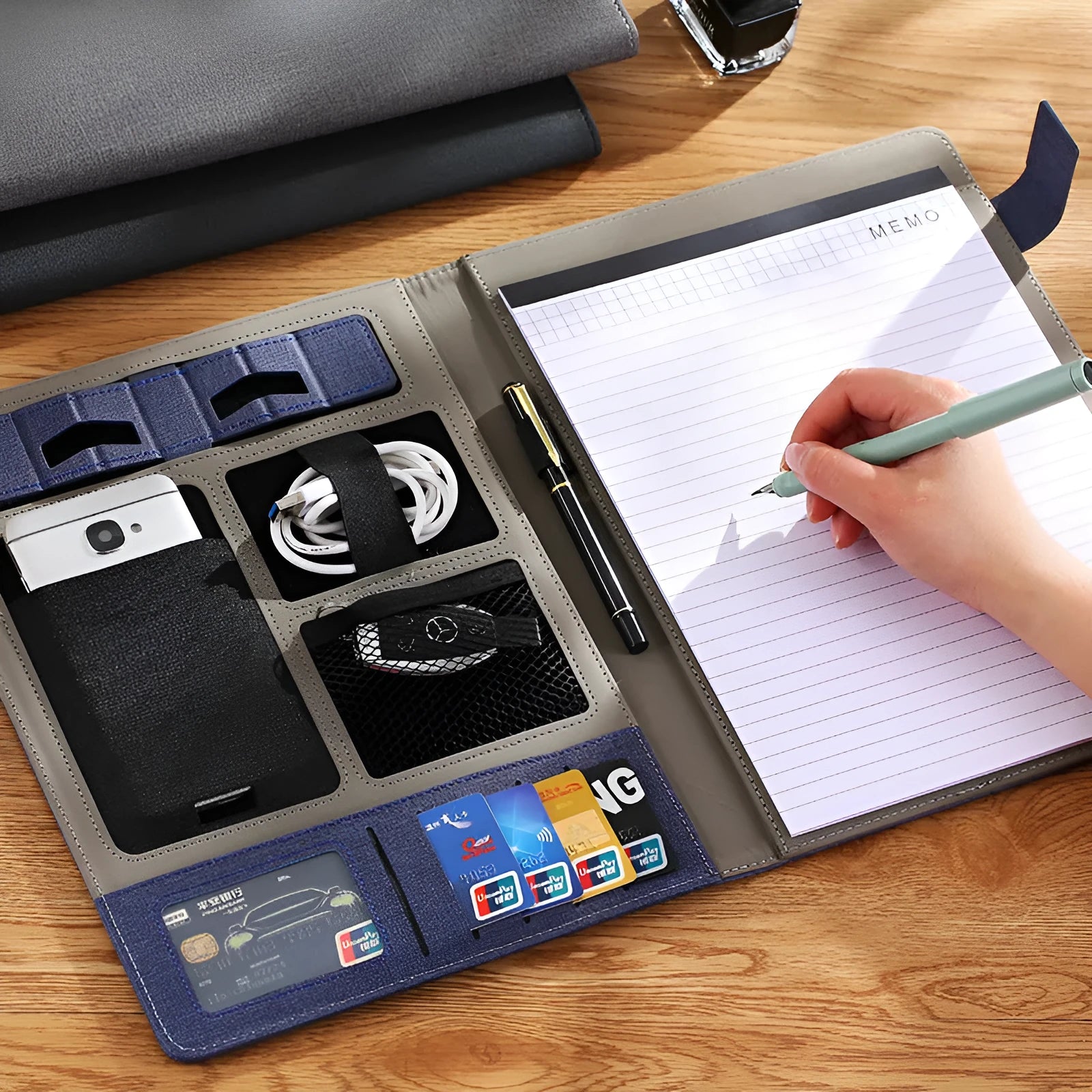 Black leather A4 multifunction folder holding documents and a pen, showing its professional design.