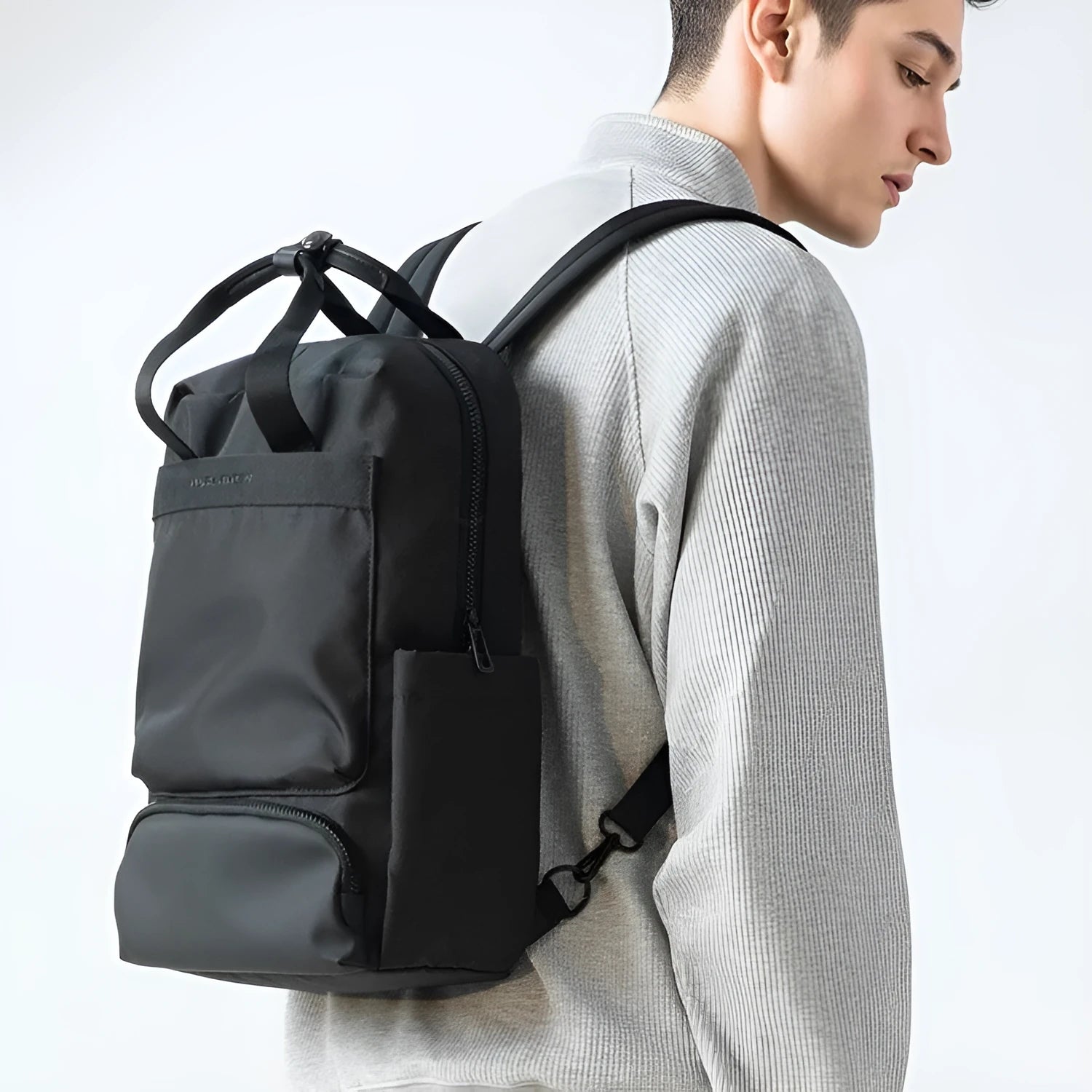 Black Oxford cloth computer backpack with a polyester lining, showing storage compartments.