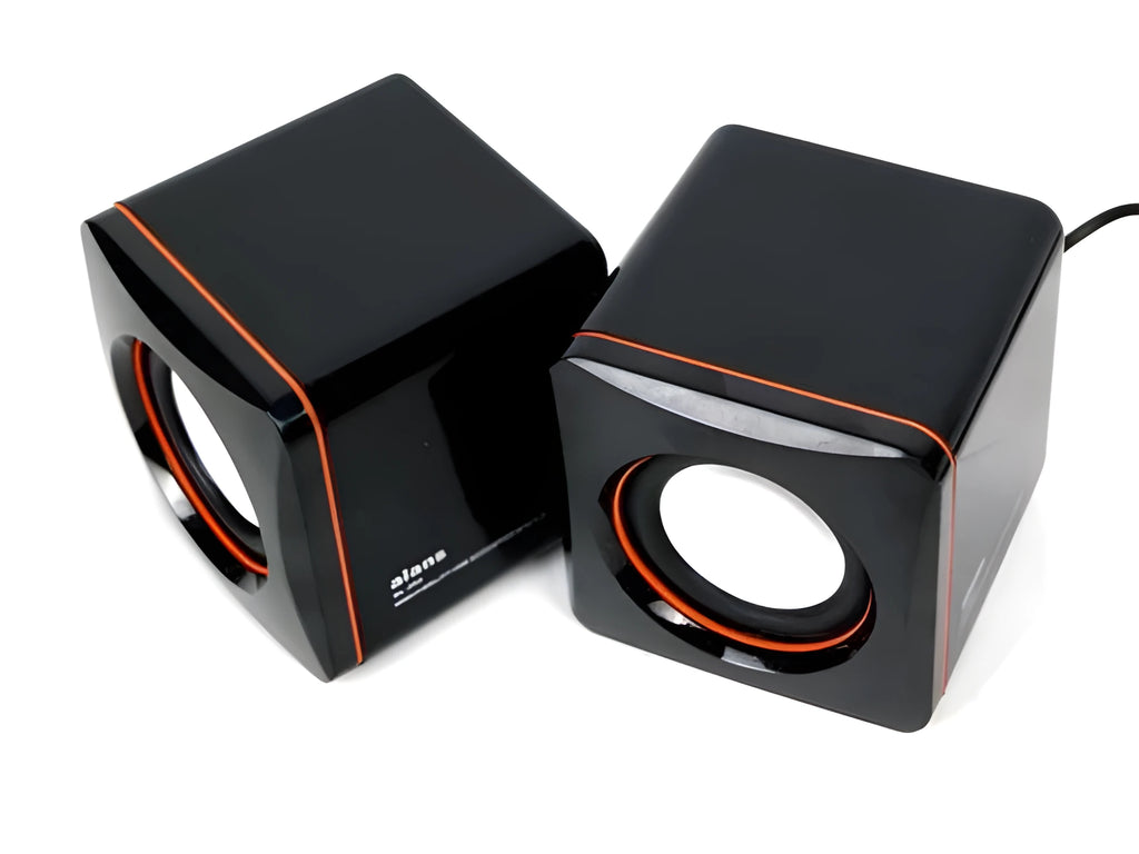 Small square black USB speaker for Model 700B computer on a desktop
