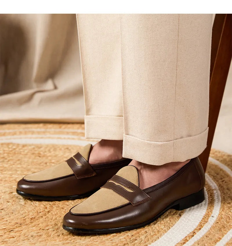 Coffee grey suede slip-on loafers with a rubber sole shown from the side.