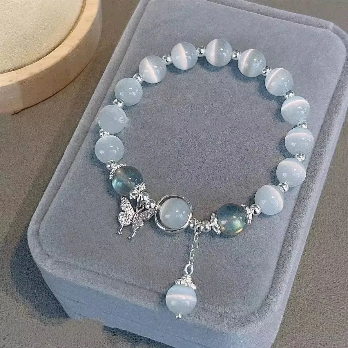Women's manually crafted glass butterfly bracelet in drop shape with round elements