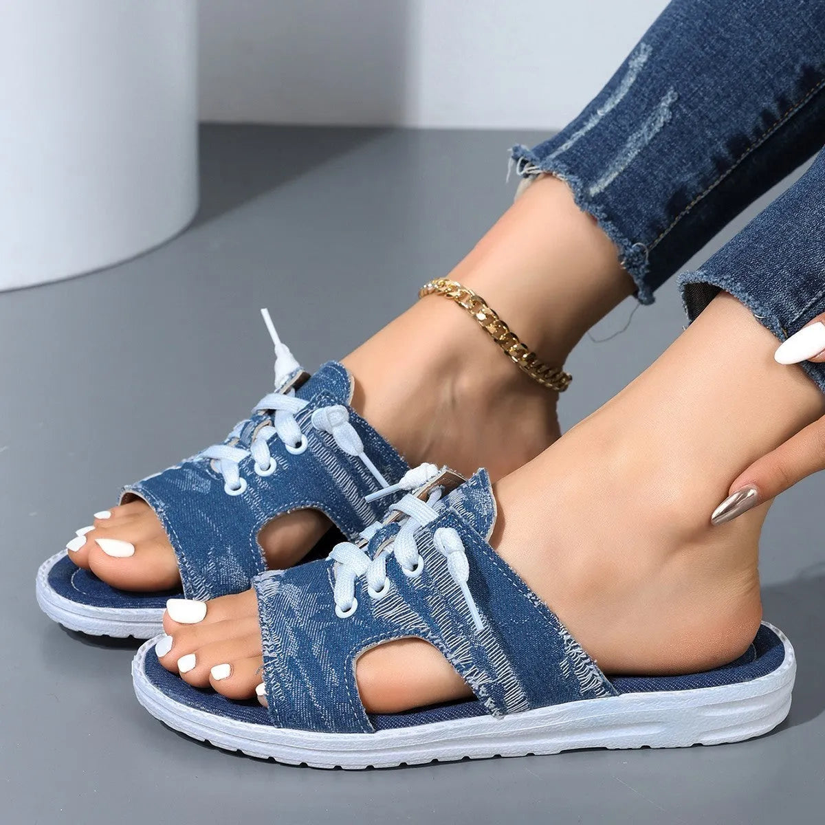 Blue Roman-style canvas slippers with flat rubber soles and cloth upper