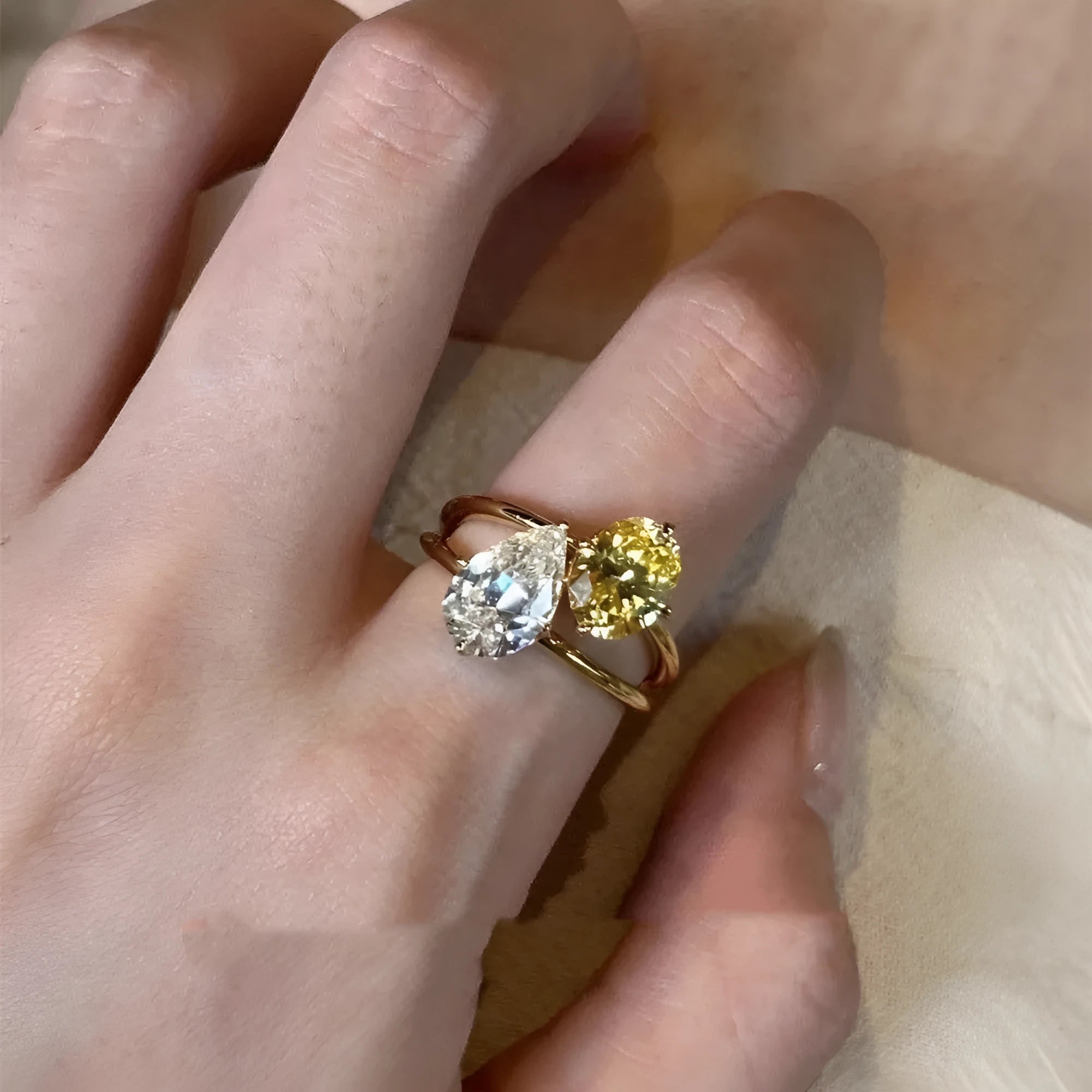 Women's open ring with geometric water drop shape and double sheng stone detailing on copper base