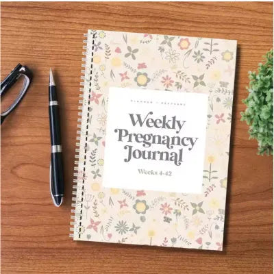 A5 pregnancy weekly diary notebook open showing weekly format pages