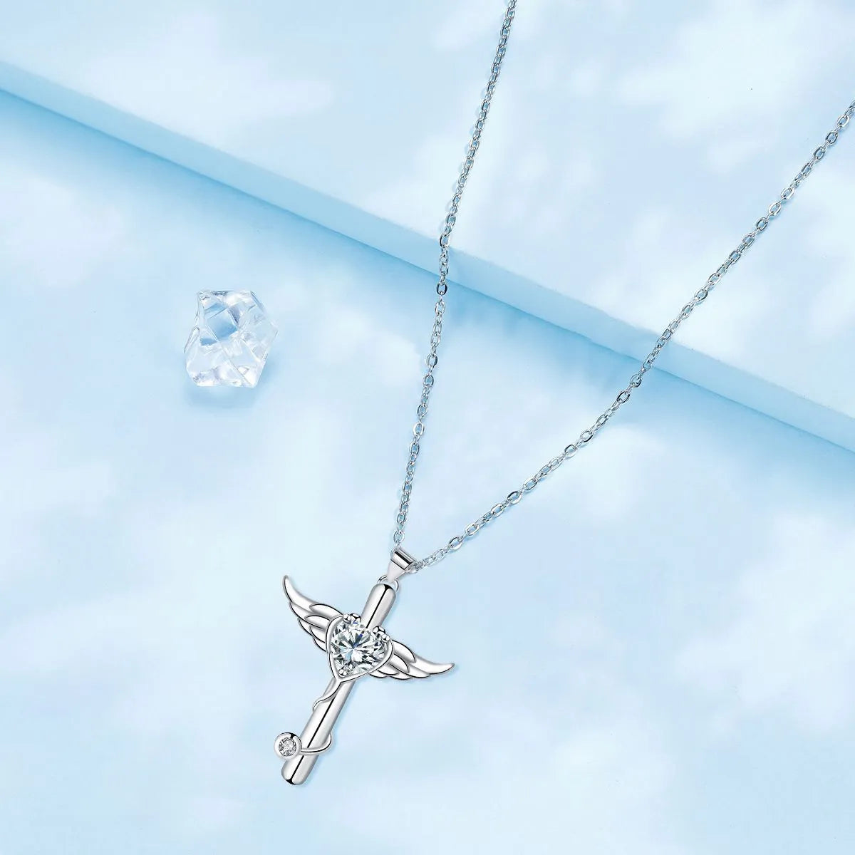 Stethoscope-shaped copper necklace with wing design elements in electroplated red or white diamond finish