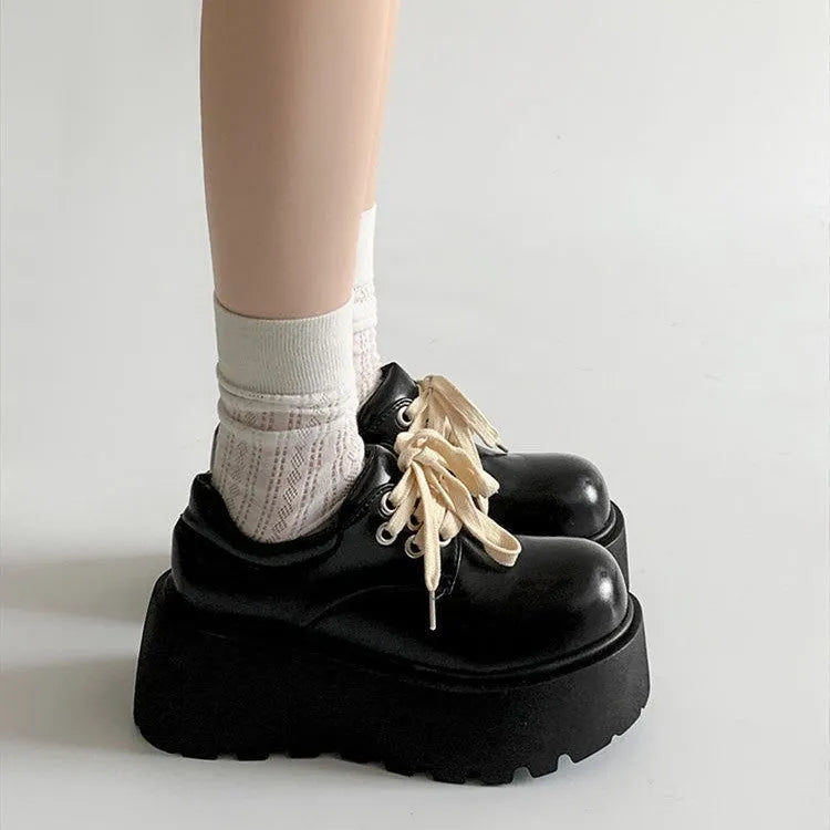 Women's matte black retro lace-up shoes with thick rubber sole and block heel.