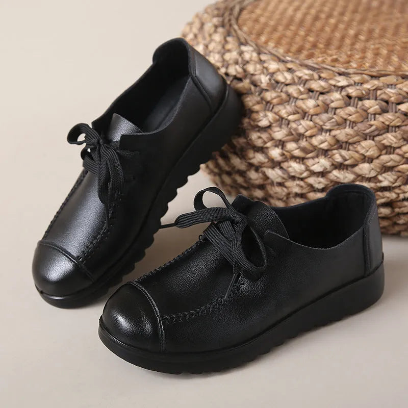 Women's black flat work shoes with round toe, front lacing, and soft anti-slip polyurethane sole