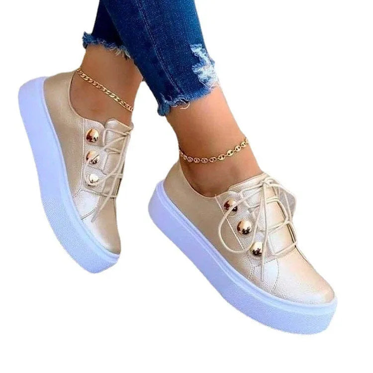 Women's white lace-up flats sneakers with silver rivet detailing and round toe design