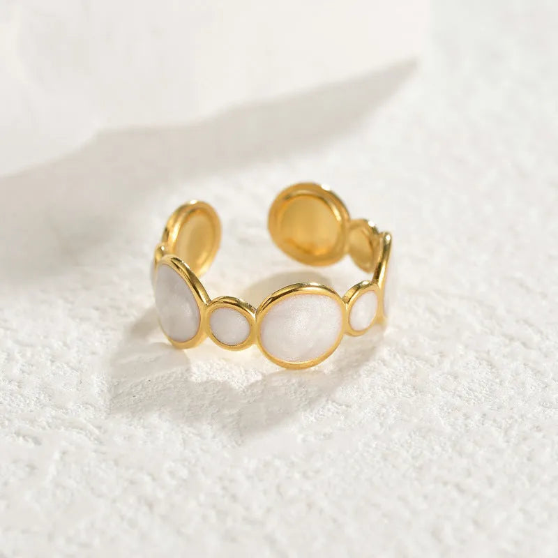 A geometric-shaped stainless steel ring with an adjustable opening on a plain background.