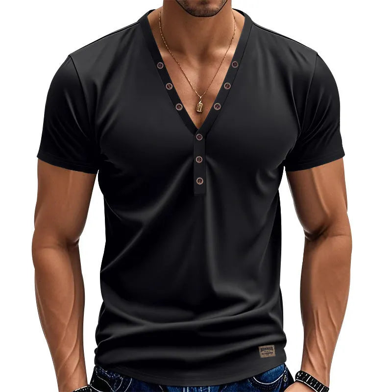 Man wearing a loose fit solid colour V-neck pullover top with a small button design detail.