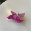 Dinosaur acrylic hair clip with jaw grip in various dinosaur designs including pink pterosaur and green stegosaurus