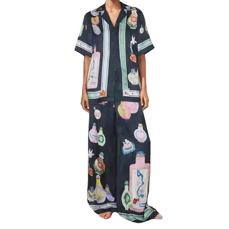 Black women's cardigan and trousers co-ord set with a cartoon pattern print.