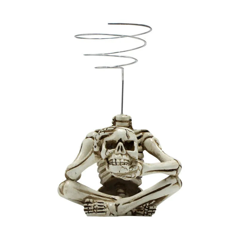 Gothic style resin skull air plant bracket on iron wall mount for soilless tillandsia display.