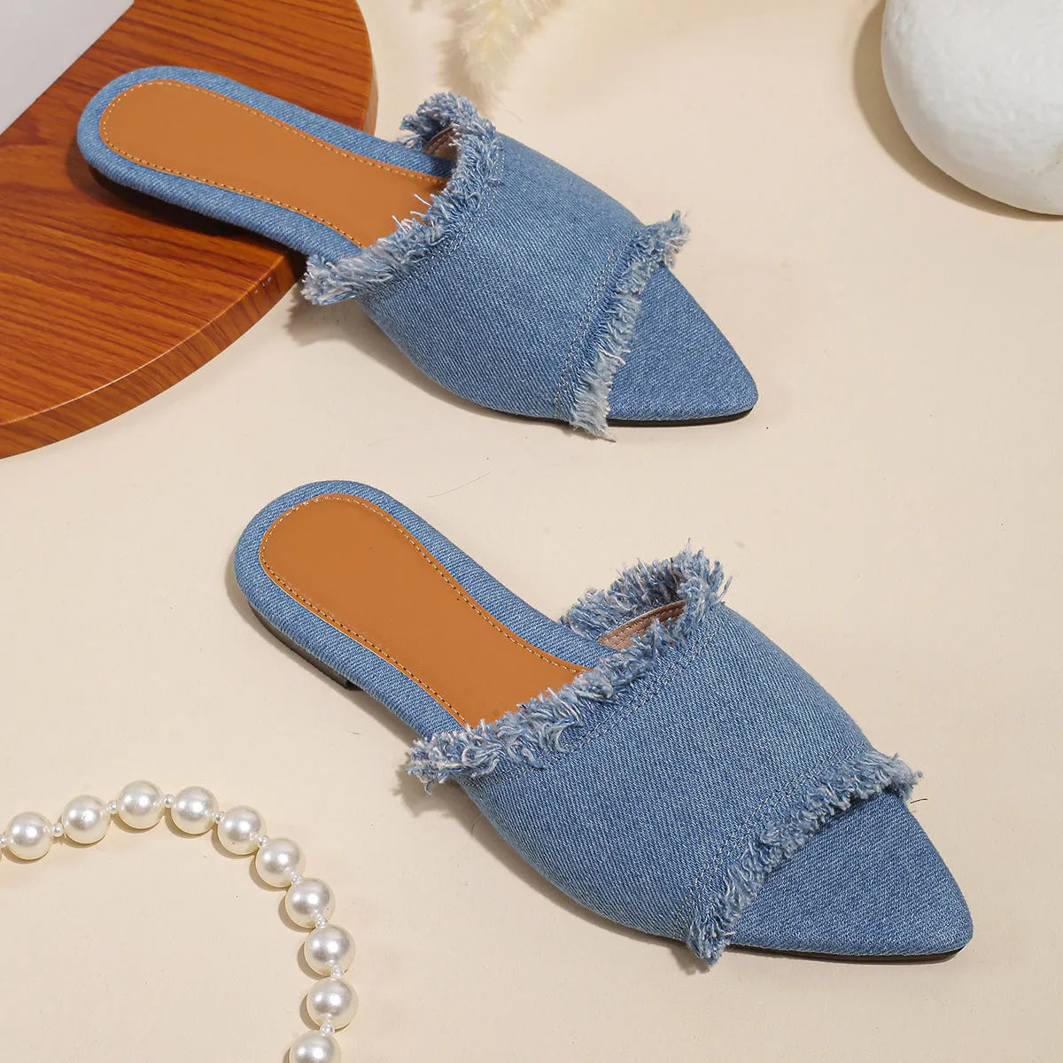 Women's denim flat slippers with a tassel detail and leather lining in a choice of colours.