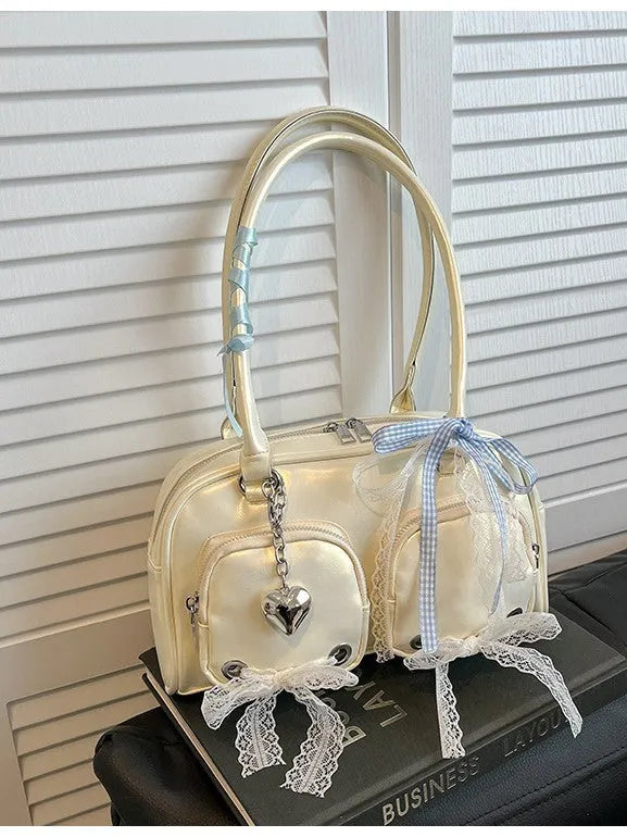 Casual shoulder bag in horizontal square design with cross-body strap, showing internal mobile phone pocket organisation