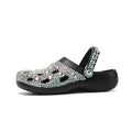 Black women's platform sandals with rhinestone details and a perforated upper on an EVA sole.